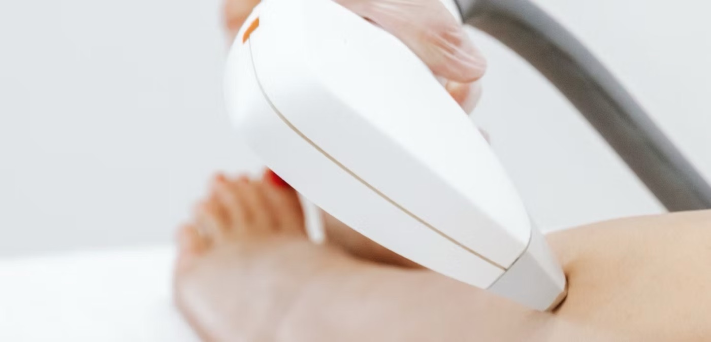 A laser handpiece treating a leg at Blanca Beauty Bar