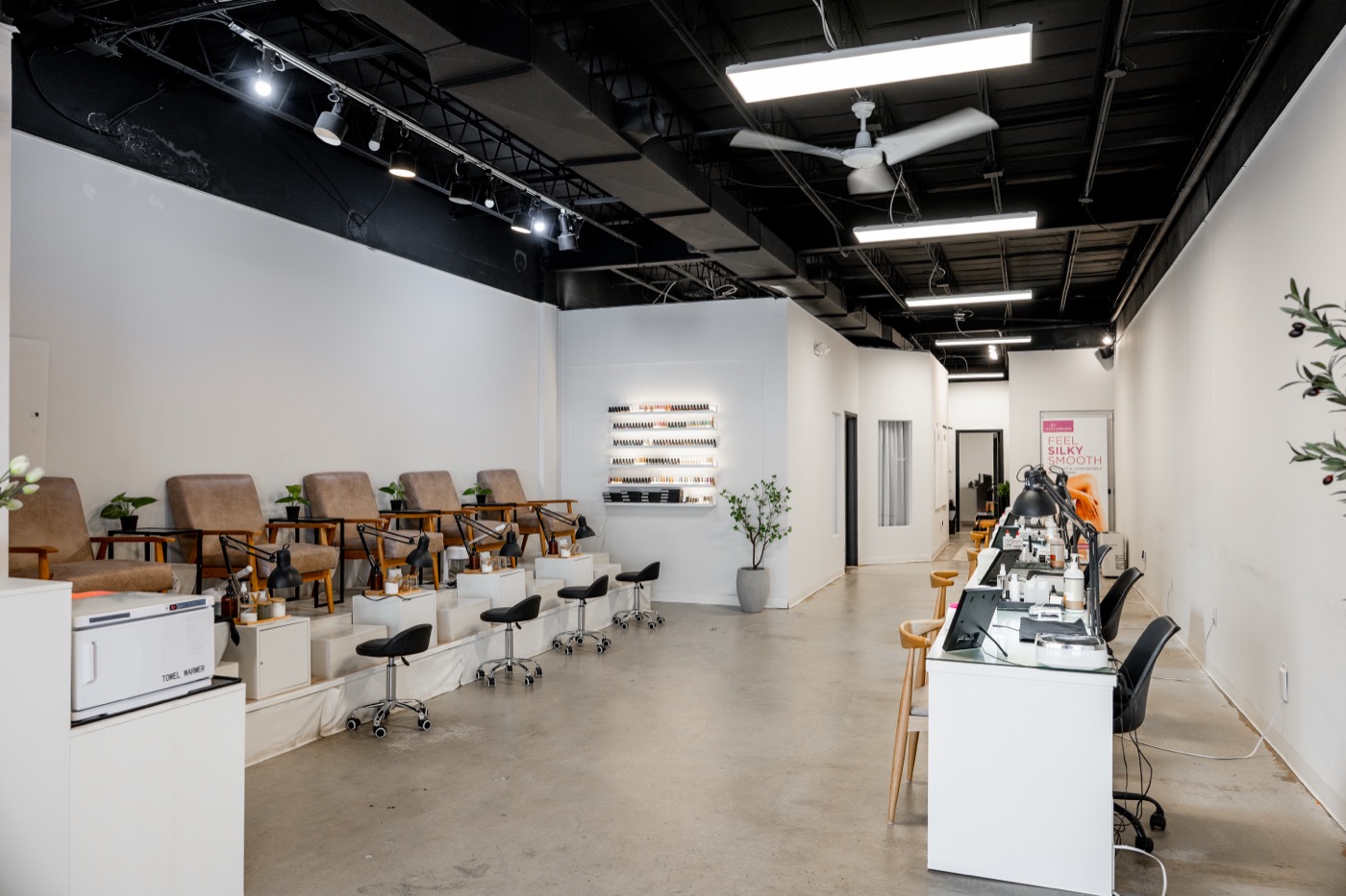 The full Blanca studio interior, pedi stations and manicure desks side by side