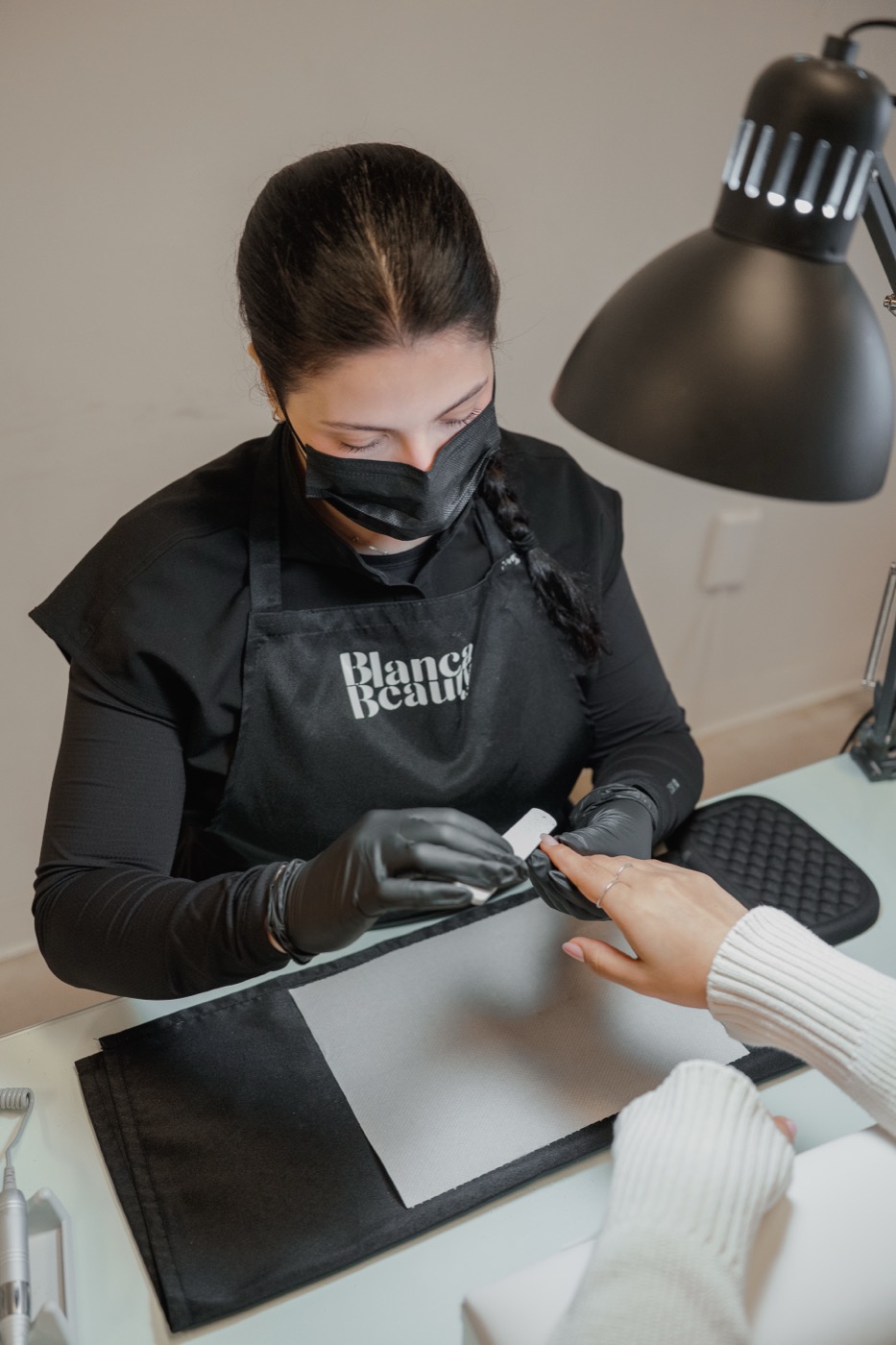 E-file cuticle work photographed from above during a manicure
